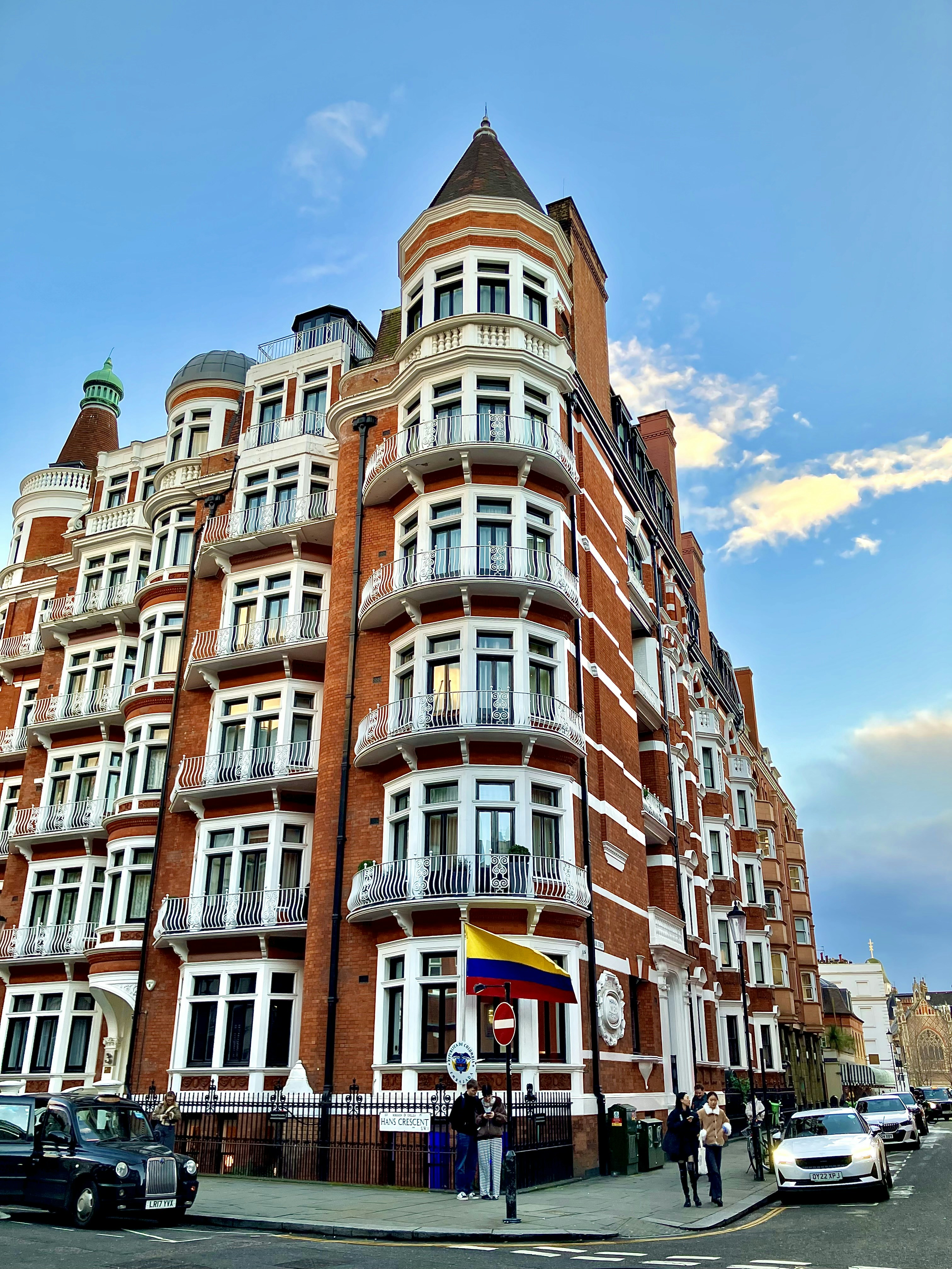 Beautiful brick building with balconies and a flag.