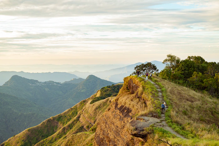 Hiker enjoying sunrise from Reiek Tlang in Mizoram