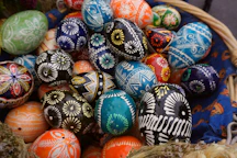 Decorated easter eggs are in a basket.