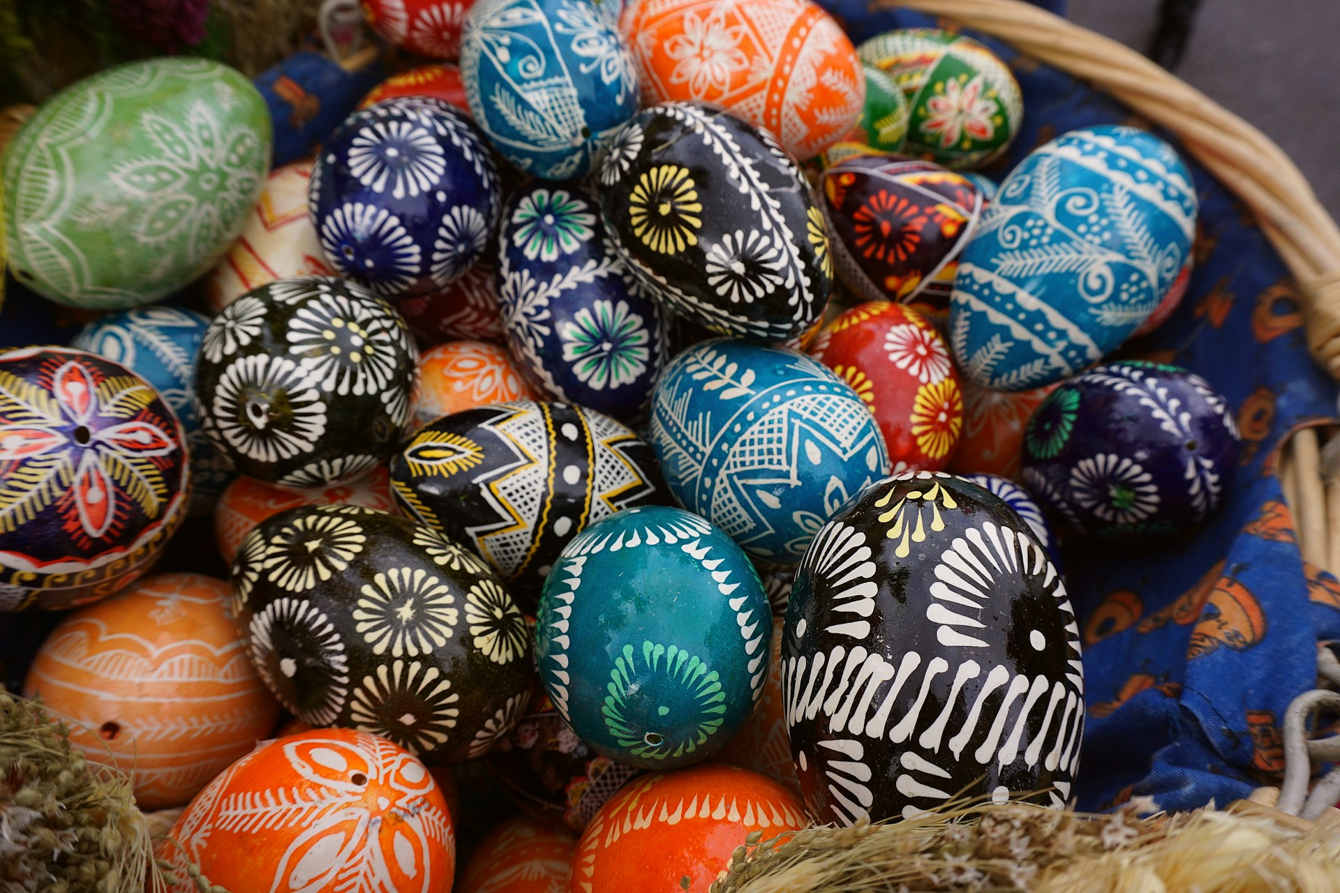 Decorated easter eggs are in a basket.