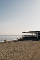Beach umbrellas and a cafe on a sandy beach.