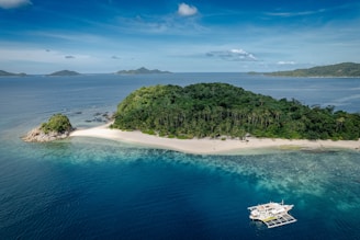 Island scenery with ocean and cloudy blue sky.