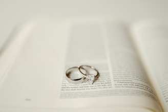 Wedding rings rest upon an open book.