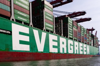 An evergreen cargo ship is docked.