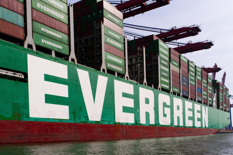 An evergreen cargo ship is docked.