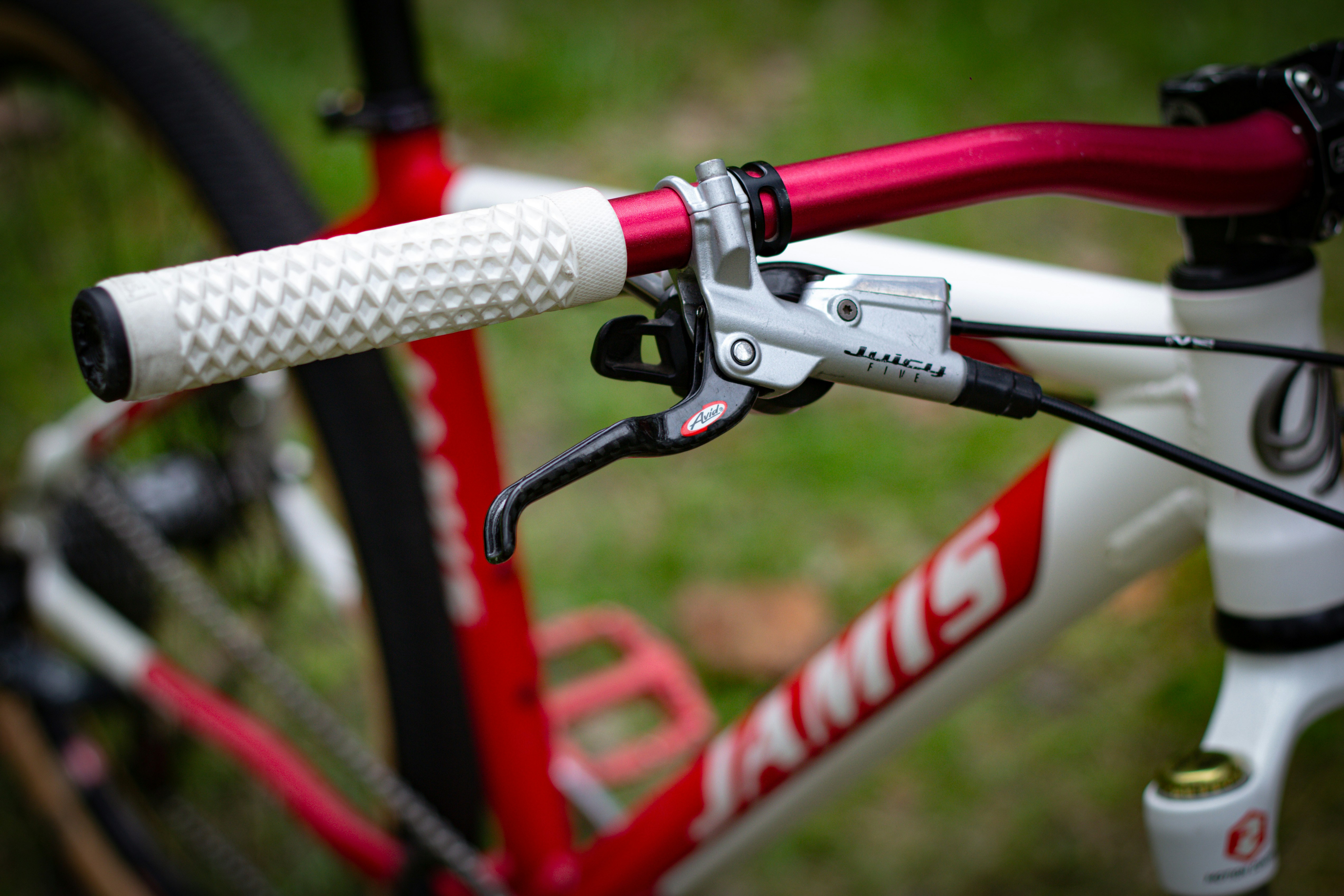 A close-up of a bicycle's handlebar and brakes.