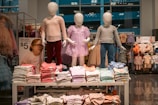 Clothing display with child mannequins at a store.