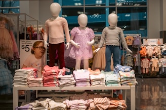 Clothing display with child mannequins at a store.