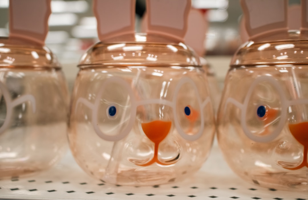 Easter bunny-shaped glasses and jars on display., A close-up of Easter-themed bunny-shaped tumblers at Target.