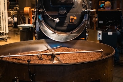 Coffee beans roasting in a giant machine.