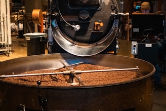 Coffee beans roasting in a giant machine.