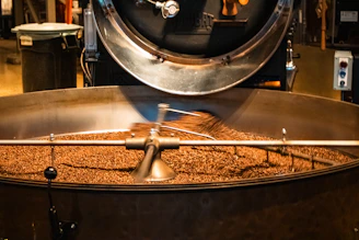 Roasting coffee beans in an industrial roaster.