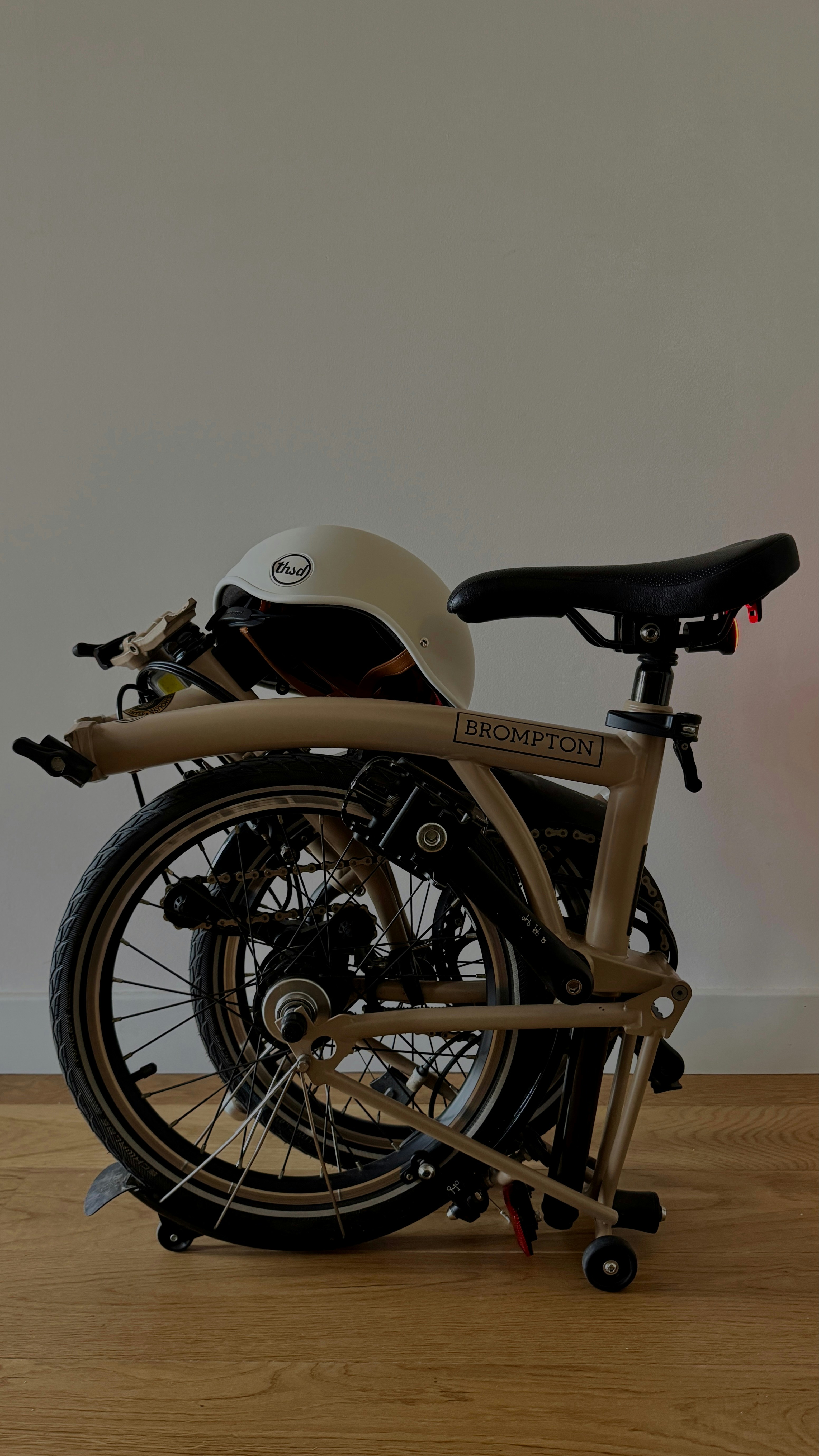 A folded bicycle with a helmet is ready.