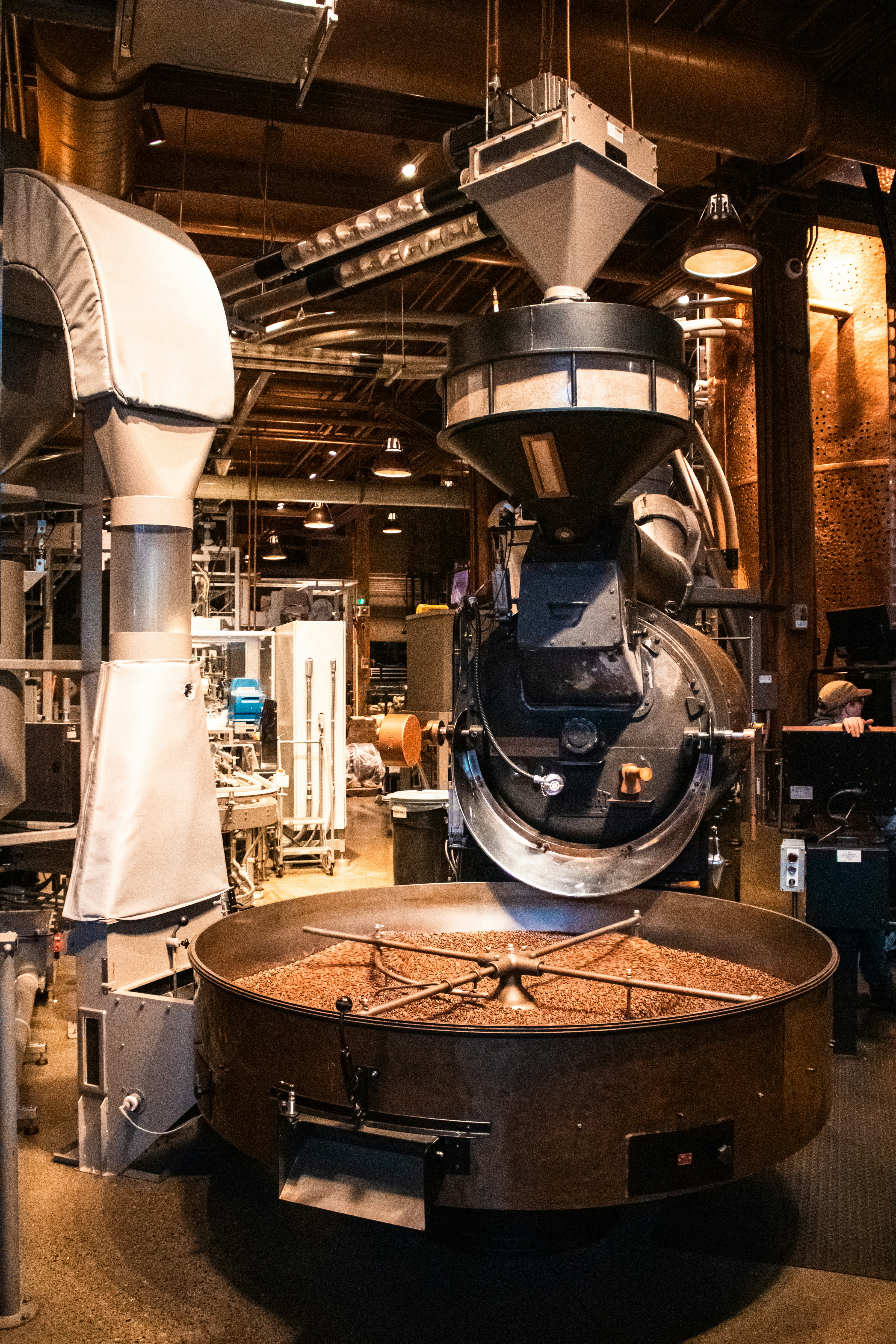 Coffee beans roasting in an industrial machine.