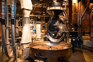 A coffee roaster roasts coffee beans in a large factory.