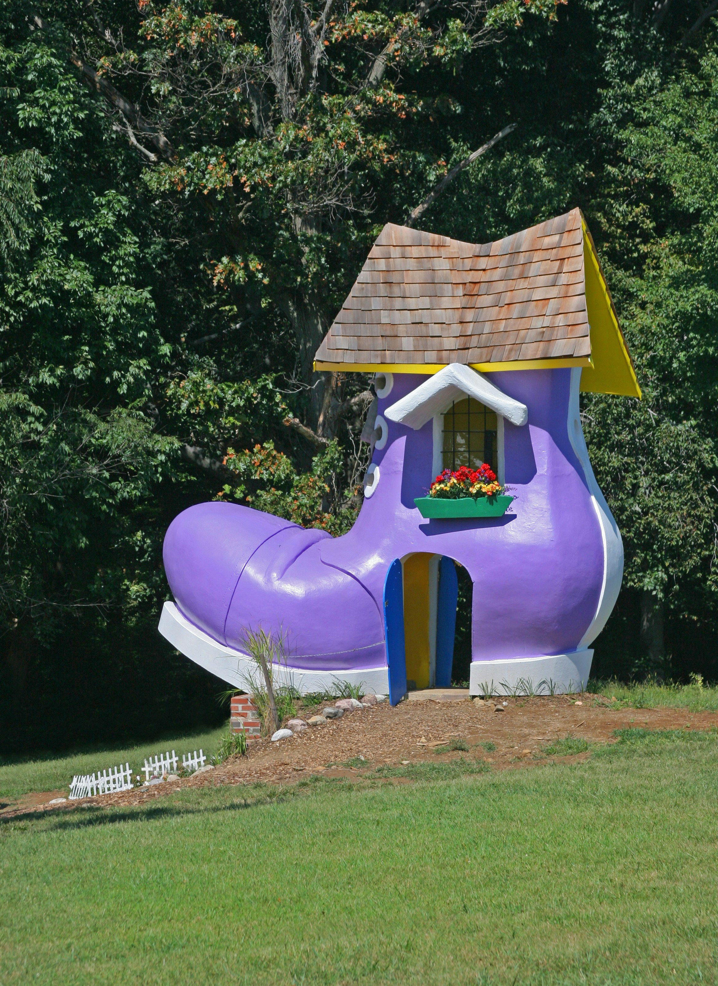 A giant purple boot serves as a quirky house.