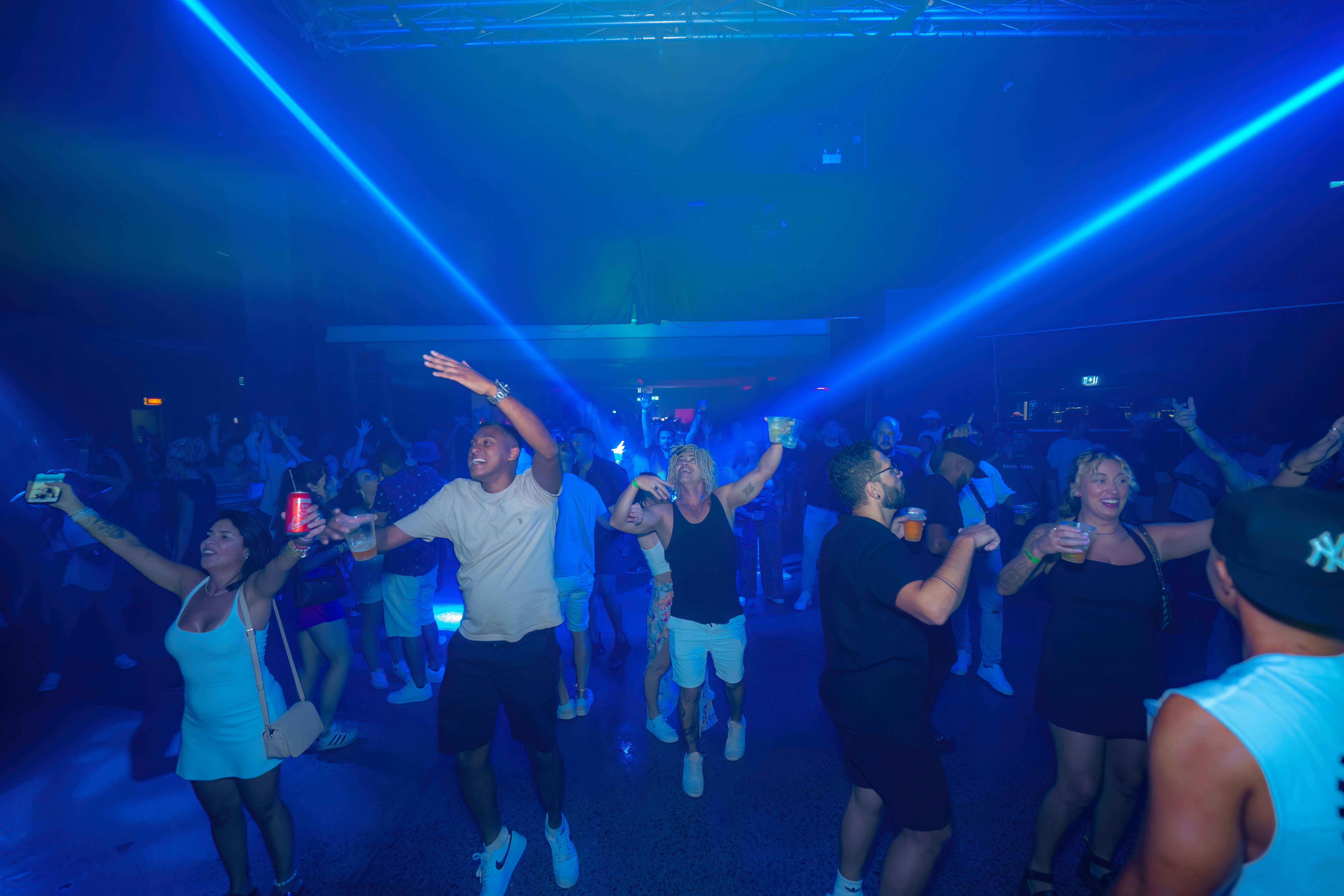 People are dancing and partying in a nightclub.