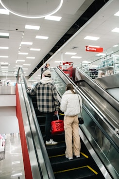 People ride the escalator in a retail store.