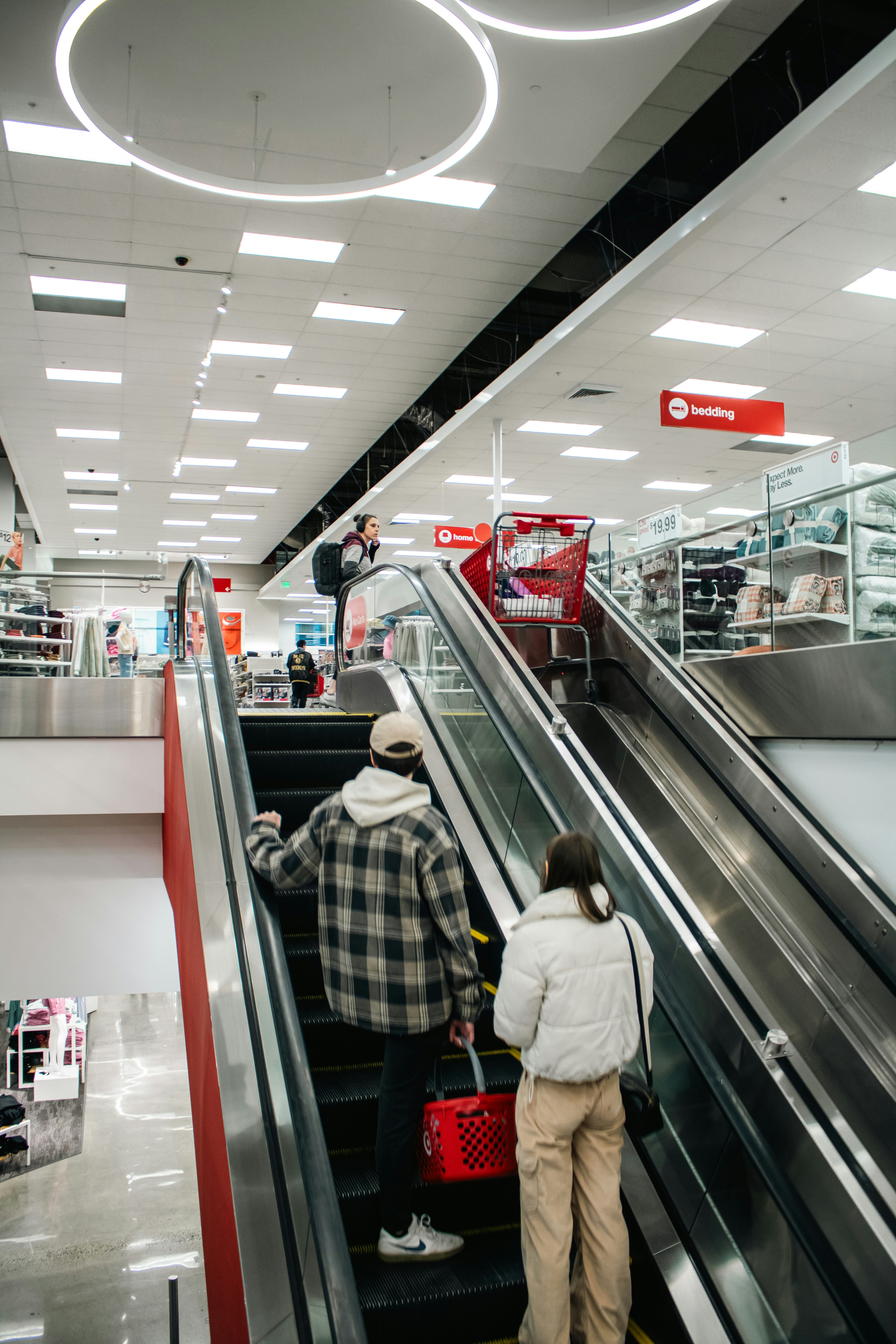 People ride the escalator in a target store.