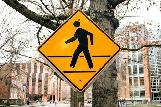 Yellow pedestrian crossing sign warning drivers of a crosswalk ahead, like the school crossings Clark County is funding more guards for