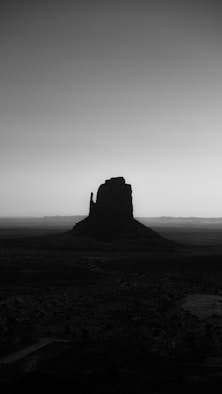A monument valley butte in silhouette.