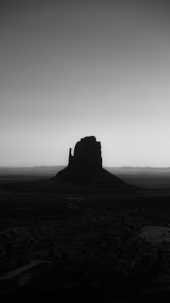 A monument valley butte in silhouette.