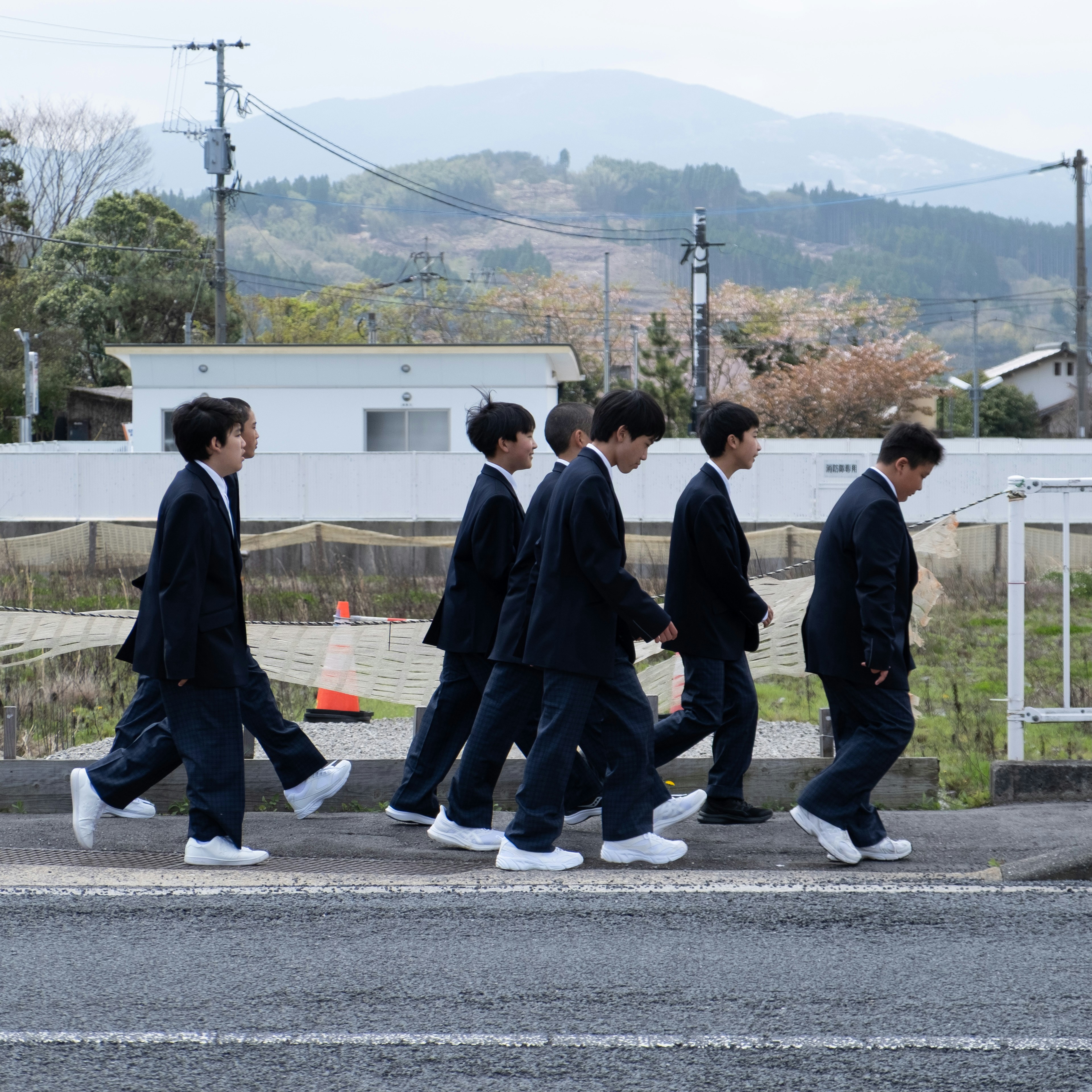 Schoolboys in uniform walking down the street.