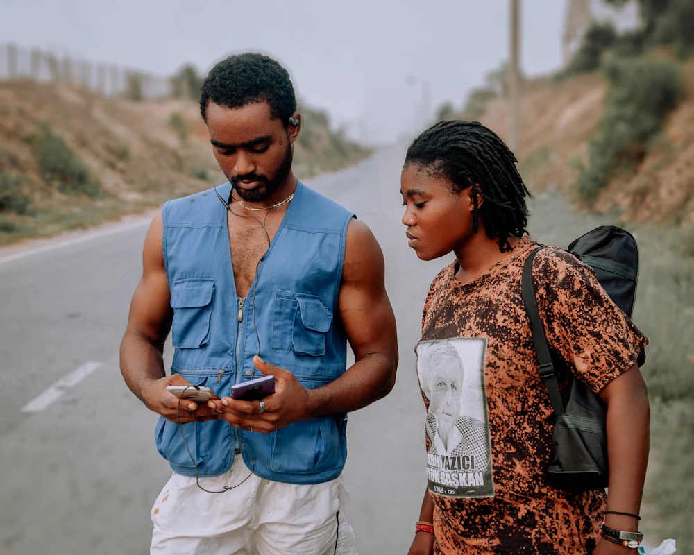 A young Ghanaian couple checking their mobile phones