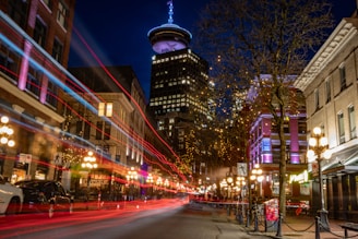 Night scene with a city skyscraper and moving lights.