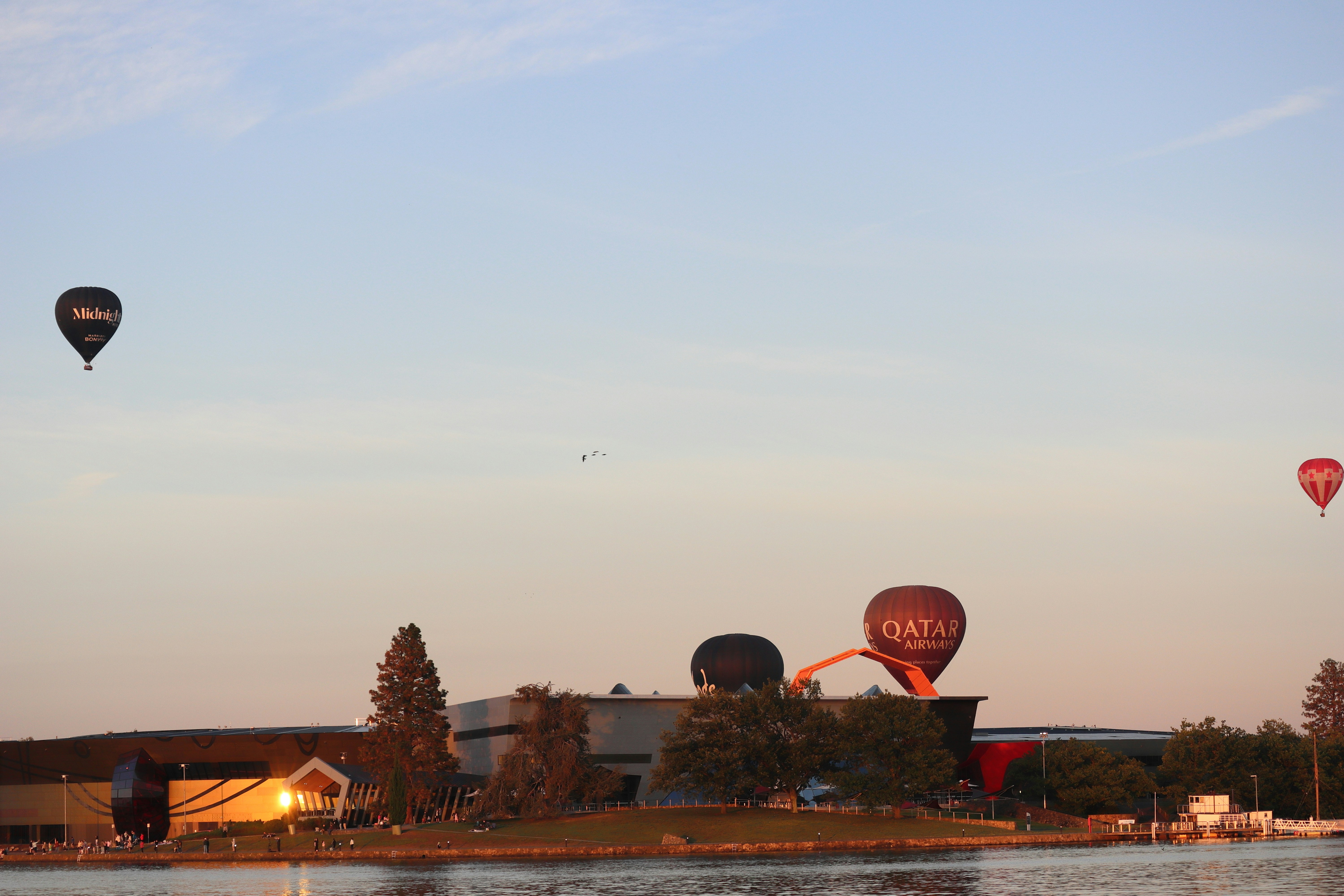 Hot air balloons are flying in the sky.