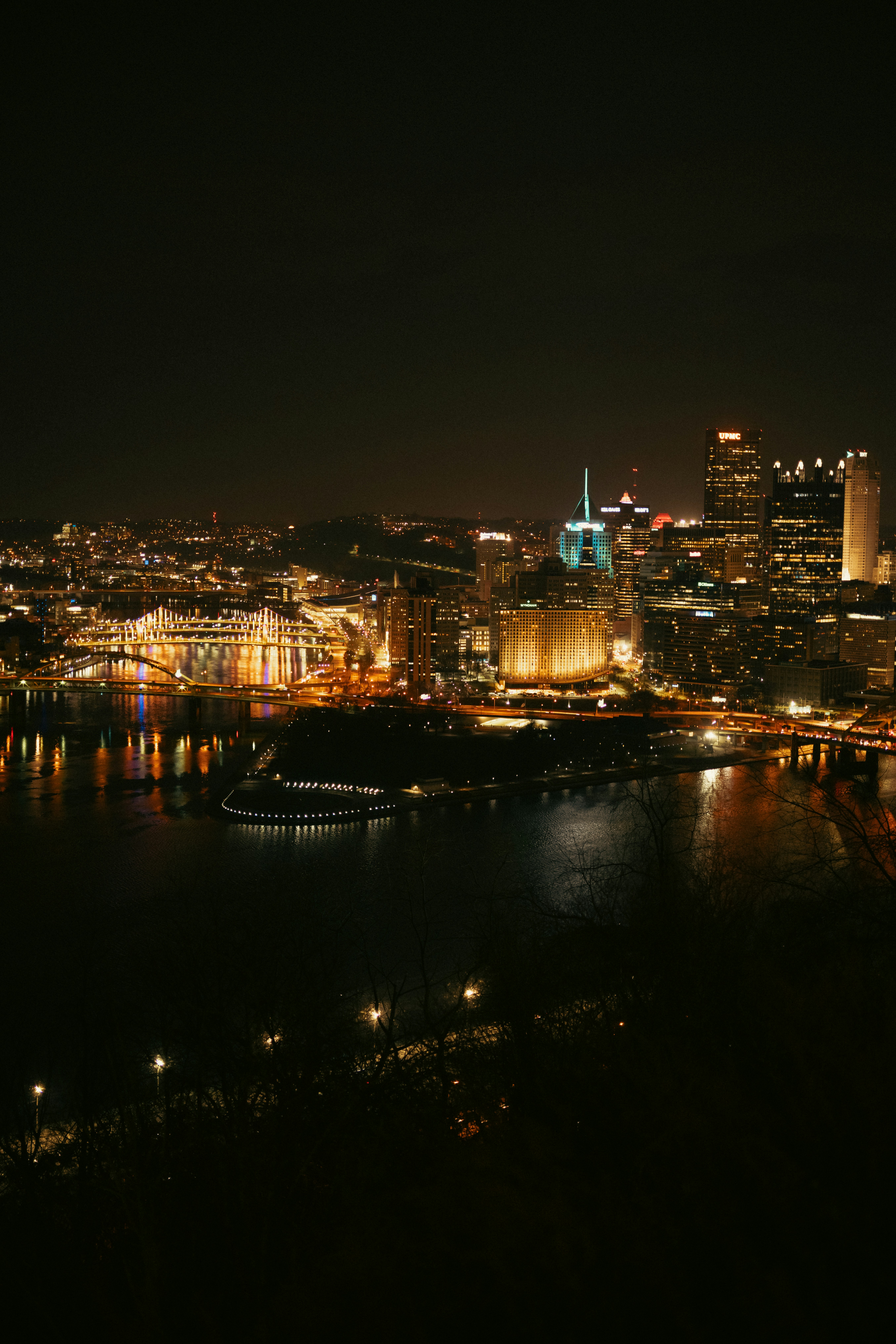 Night view of a city skyline with bright lights.