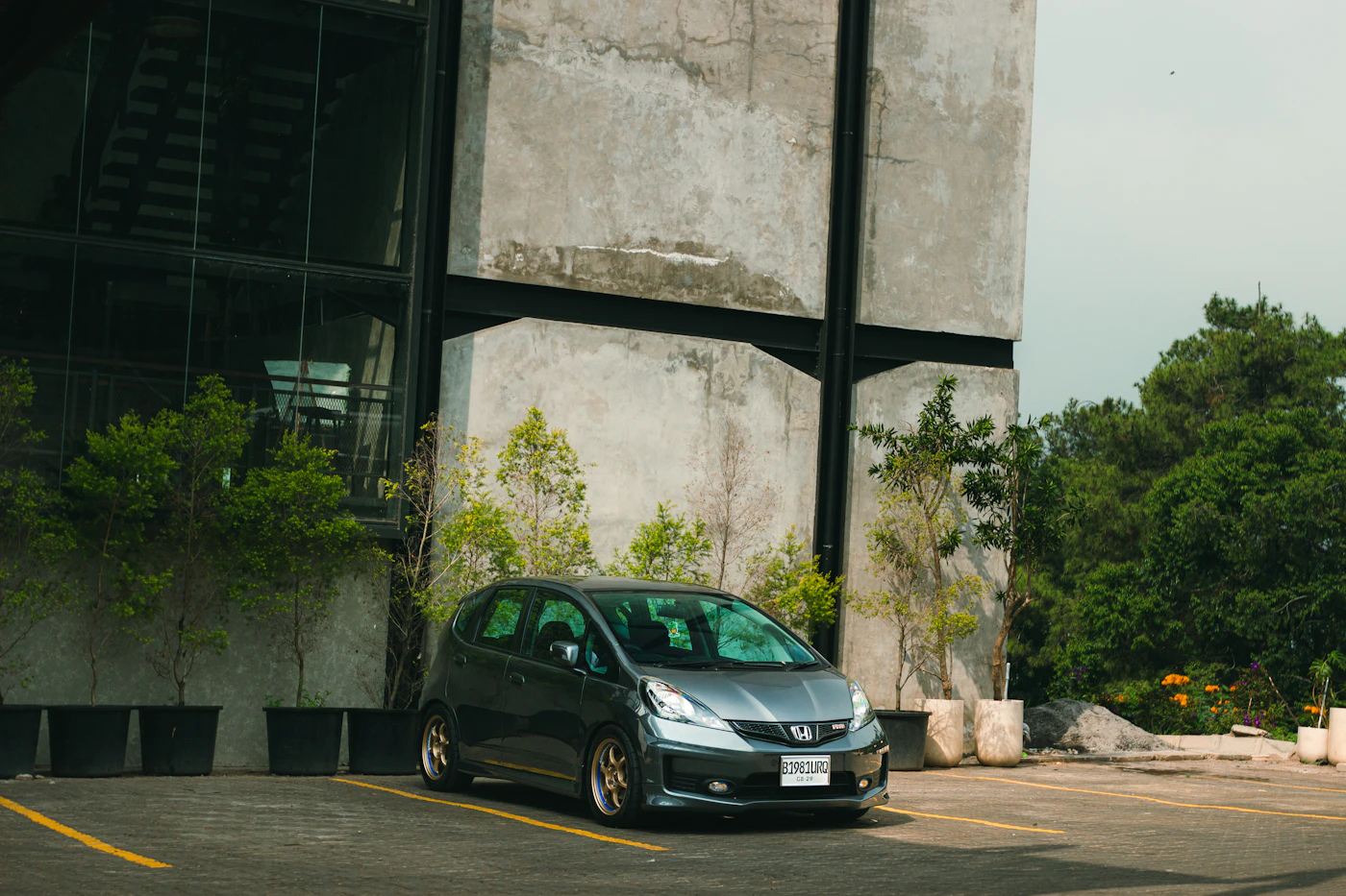 Gray car parked near a modern building
