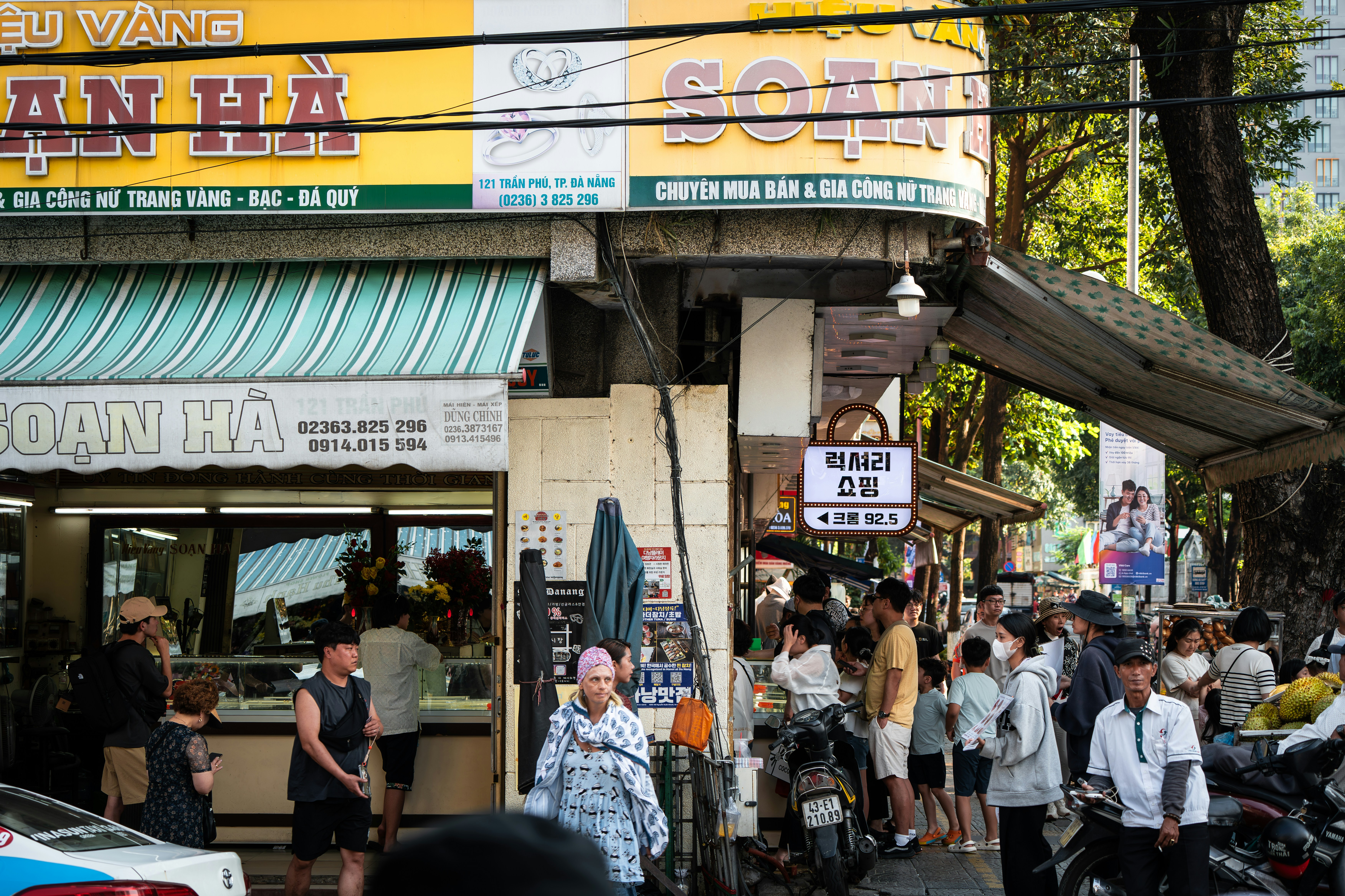 A busy street scene with storefronts and people. photo – Free Green ...
