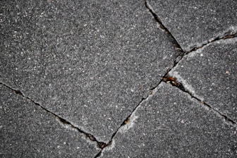 Cracked pavement shows damage and deterioration.