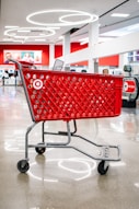 Red target shopping cart inside a store.