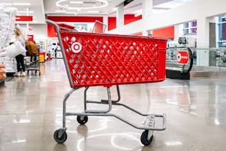 A red target shopping cart sits in an aisle.