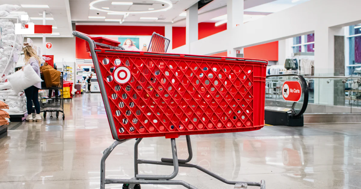 A red target shopping cart sits in an aisle. photo – Free Human Image ...