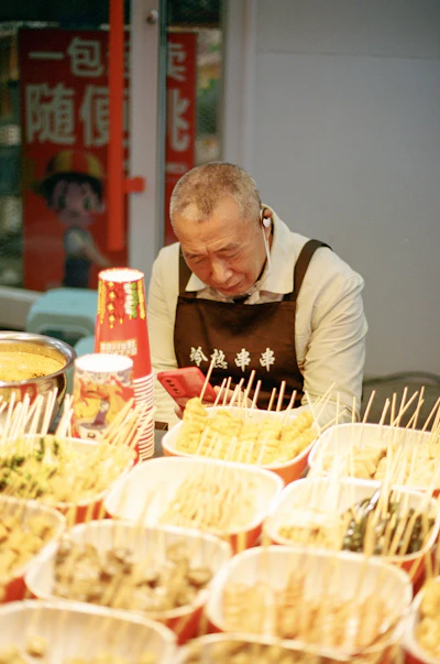 A street food vendor selling food at an outdoor market stall