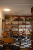 A cozy cafe with shelves full of products.
