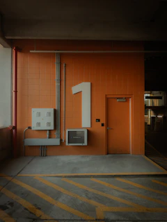 Orange wall shows the number one and a door.