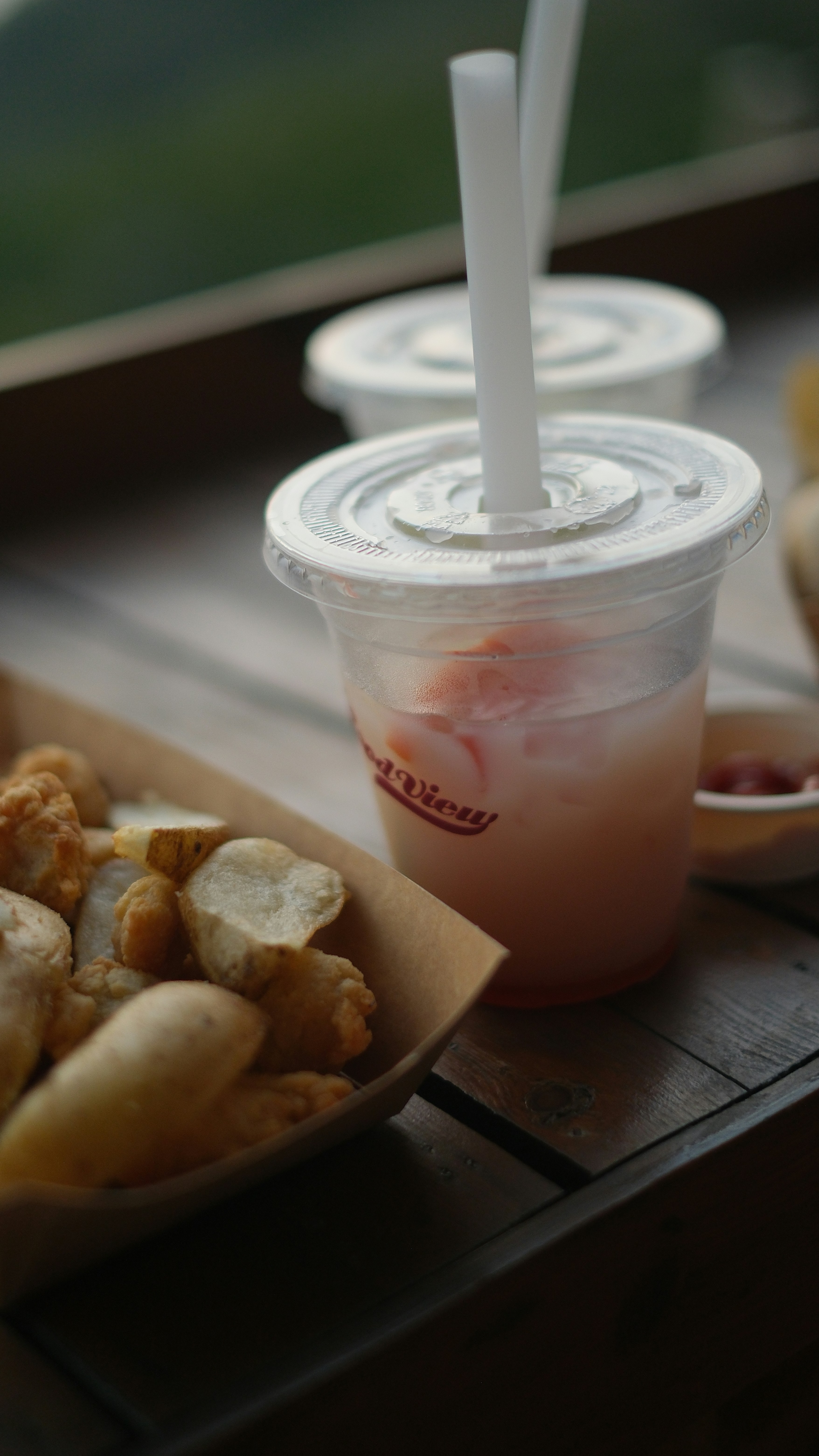 Drinks and fried food await on a wooden table