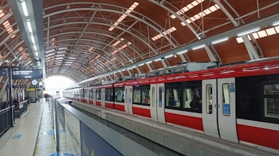 A red train waits at the modern station.
