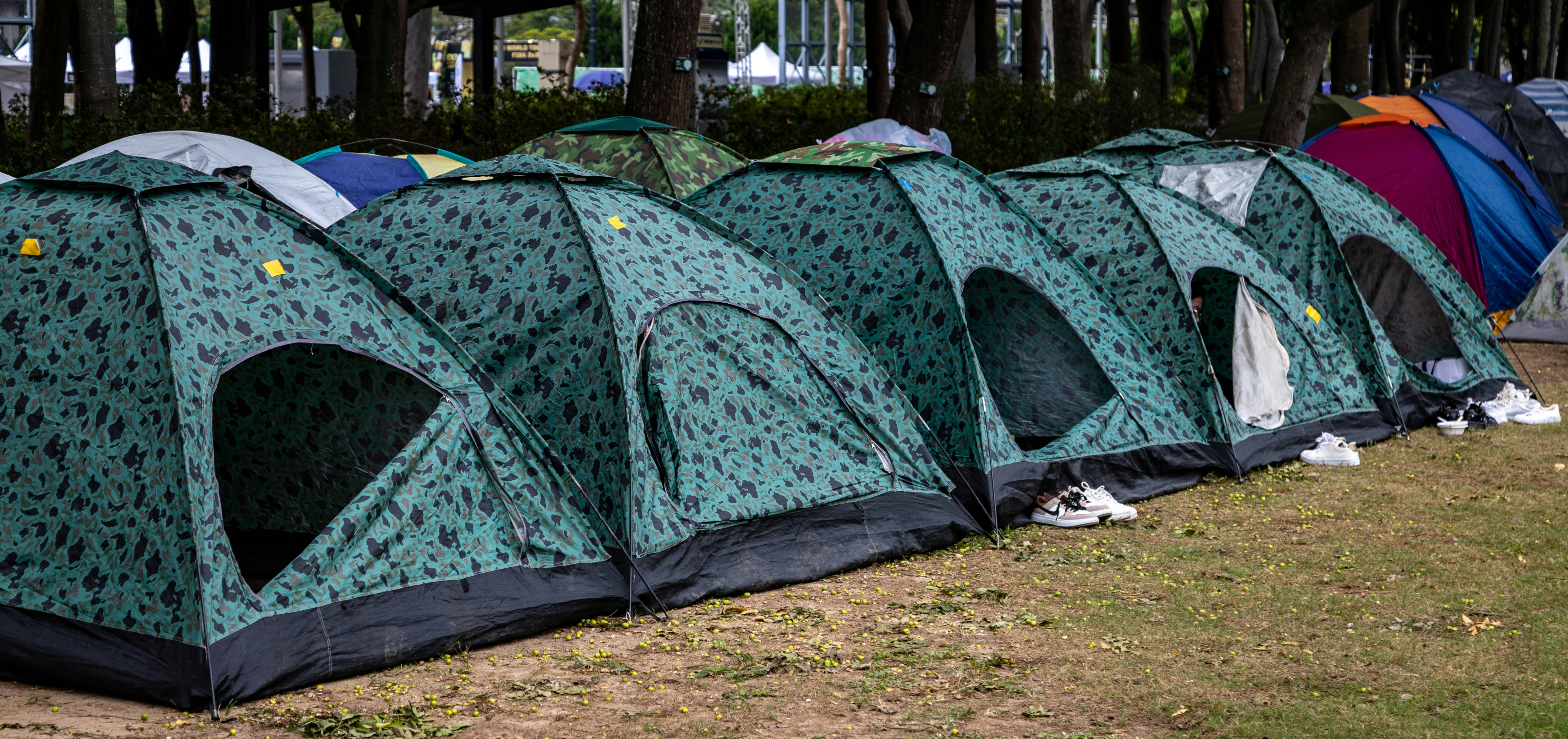 Cozy camping setup in urban park with tents and community gathering space
