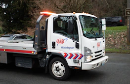 Flatbed tow truck transporting car – roadside assistance lead generation
