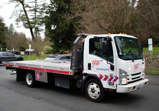 A tow truck is driving on a street