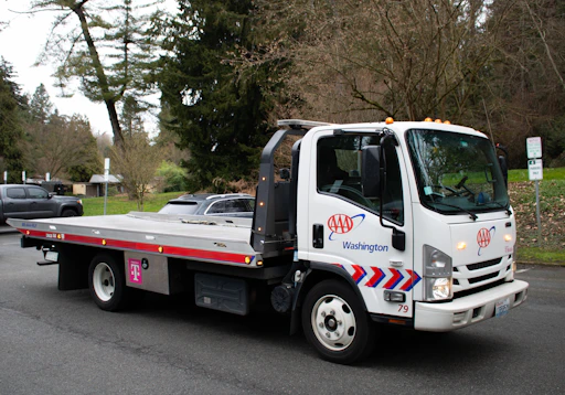 A tow truck is driving on a street