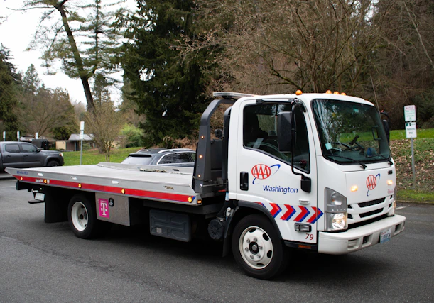 A tow truck is driving on a street