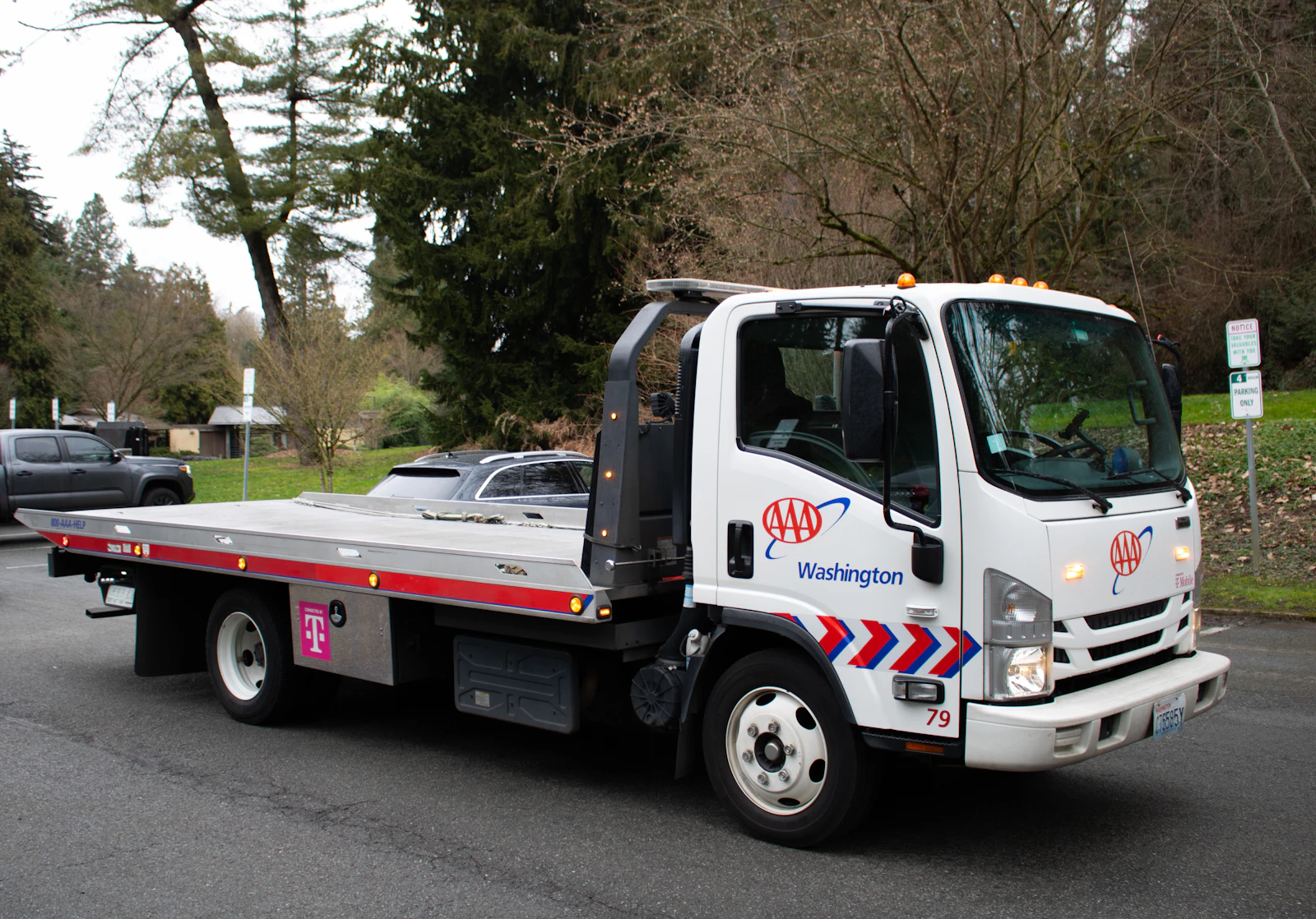 A tow truck driving on a street