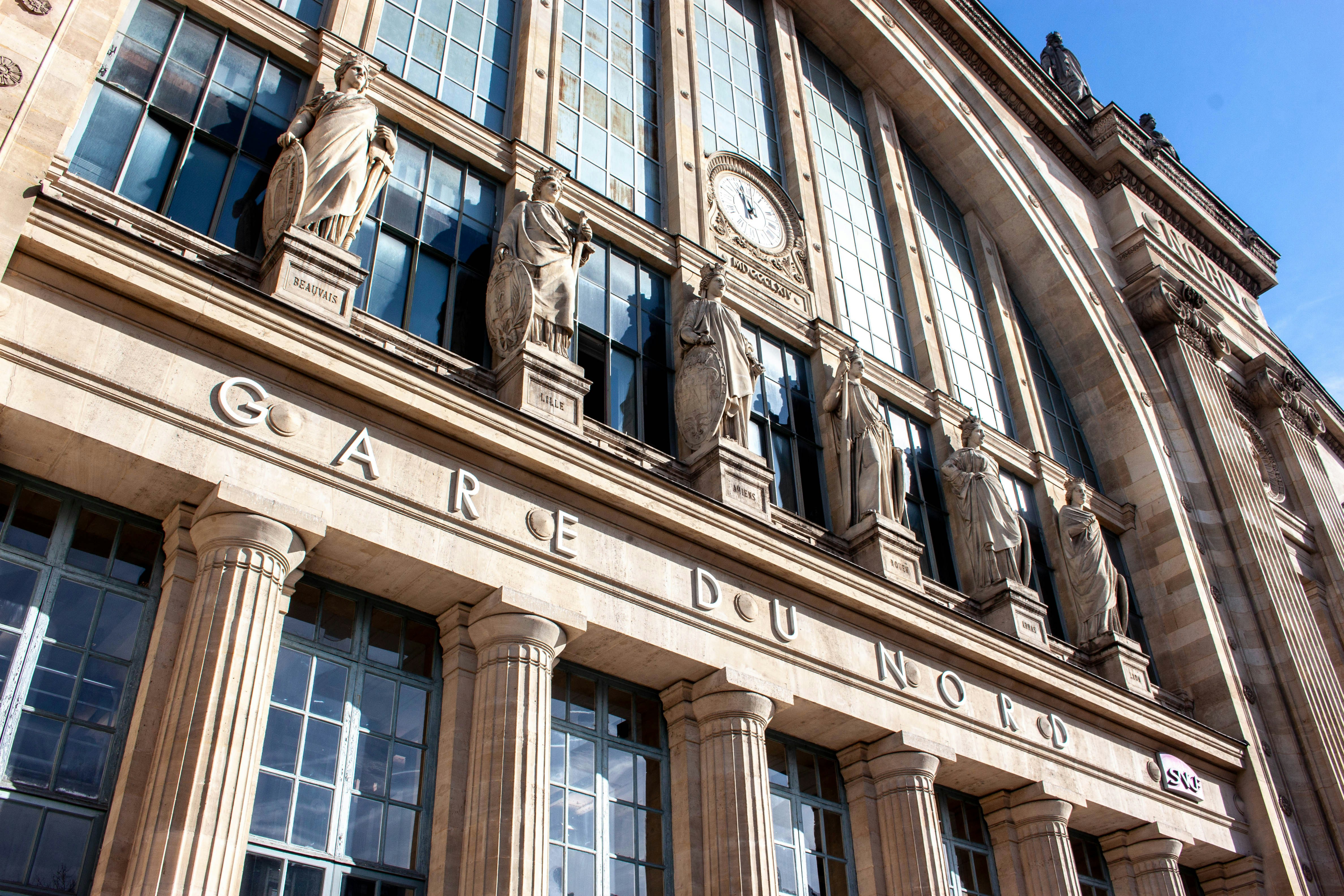 An ornate building facade with statues is shown.
