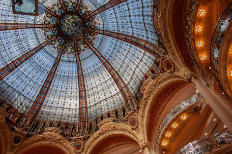 Beautiful stained-glass ceiling in an ornate building.